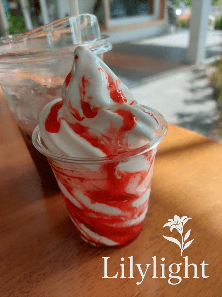 strawberry sundae with iced chocolate on a wood table