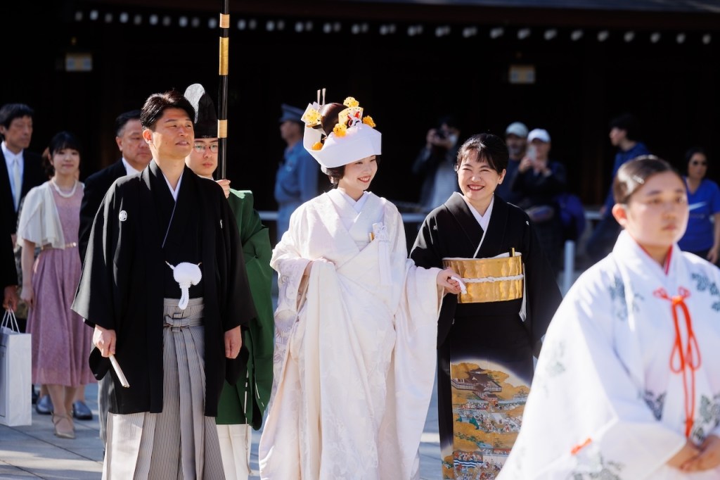 Japanese Shinto wedding procession at Meiji Jingu Shrine with bride in white shiromuku kimono
