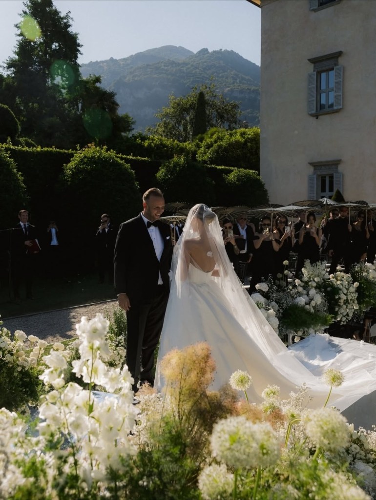 Bride and groom standing together during an outdoor wedding ceremony at Lake Como, Italy