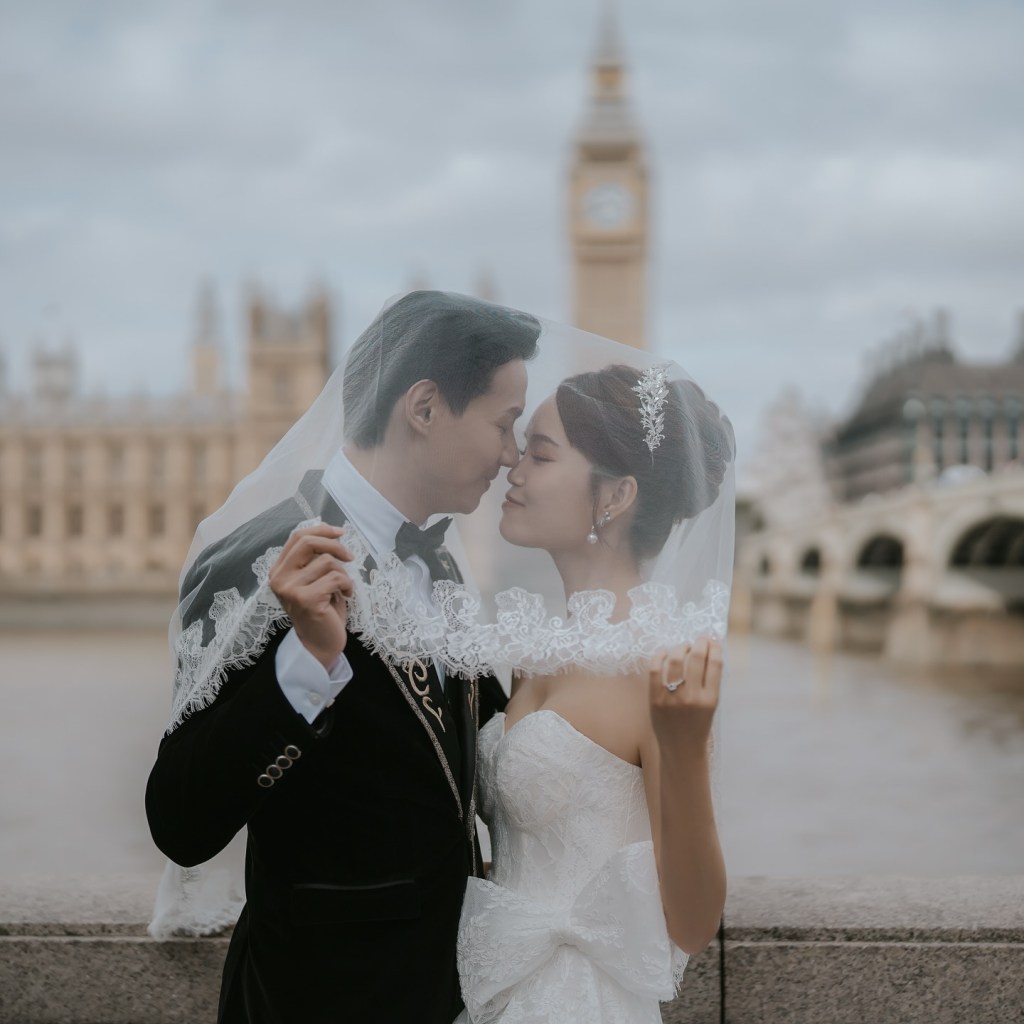 Bride and groom holding a veil together during a wedding moment near Big Ben in London